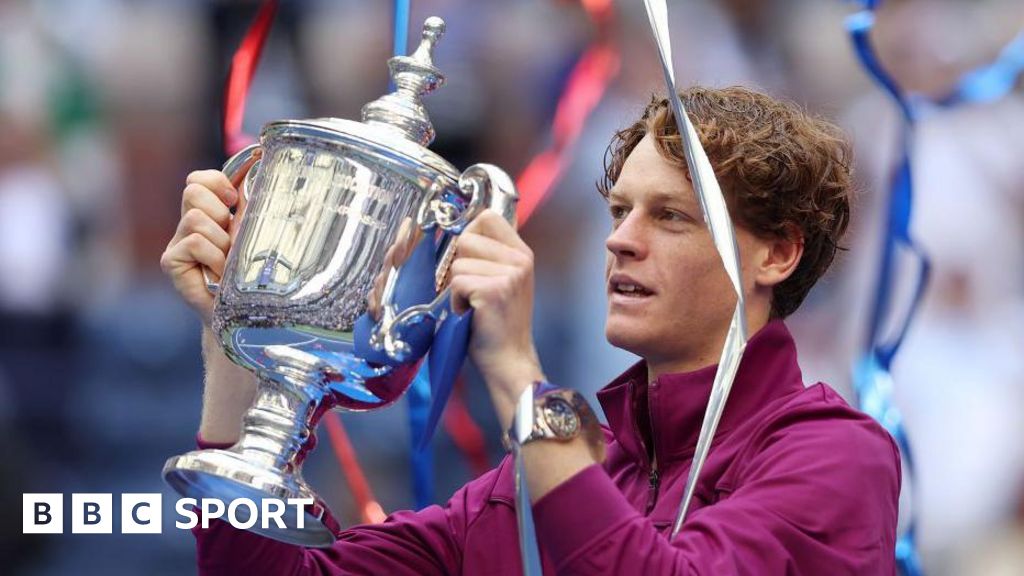 Jannik Sinner of Italy celebrates with the winners trophy after defeating Taylor Fritz